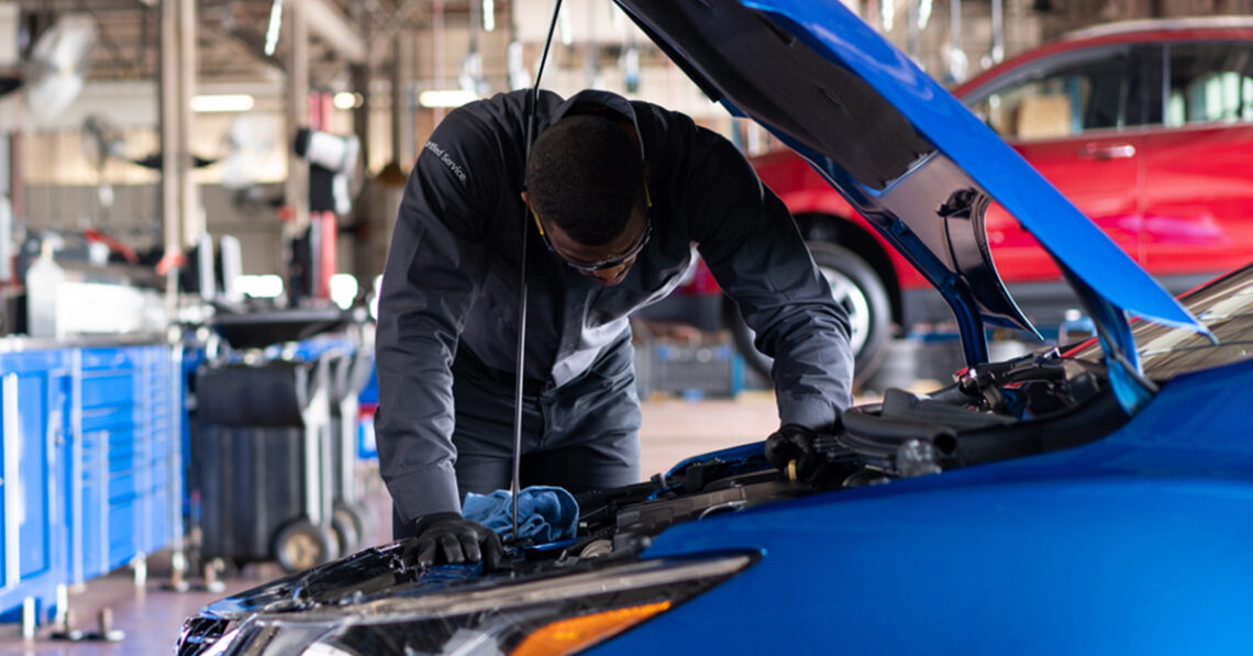 Technician Working on Chevy Engine
